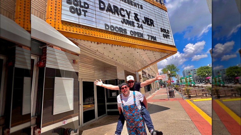 Darcy and Jer posing in front of theater