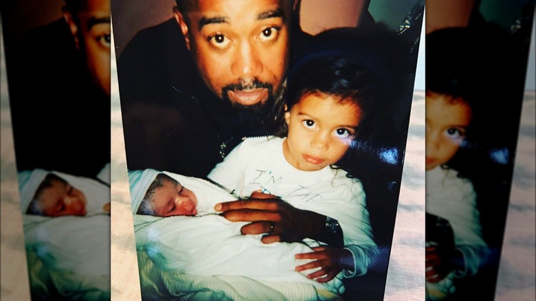 Darius Rucker and Daniella Rucker holding a baby