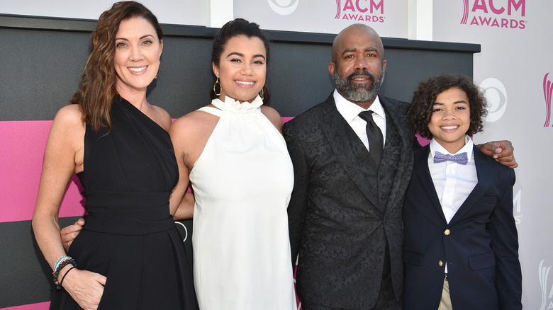 Beth Leonard, Daniella Rucker, Darius Rucker, and Jack Rucker smiling