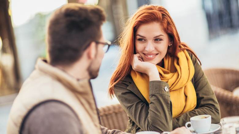 woman looks curiously at a man on a date