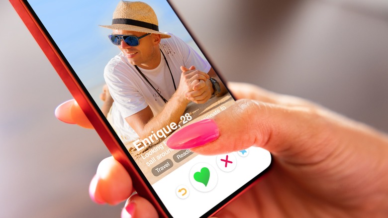 close up of woman's hand swiping on a dating app