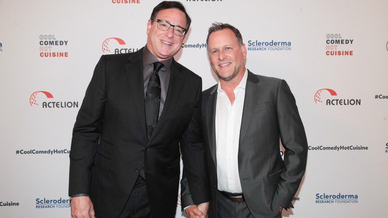 Bob Saget and Dave Coulier holding hands on red carpet