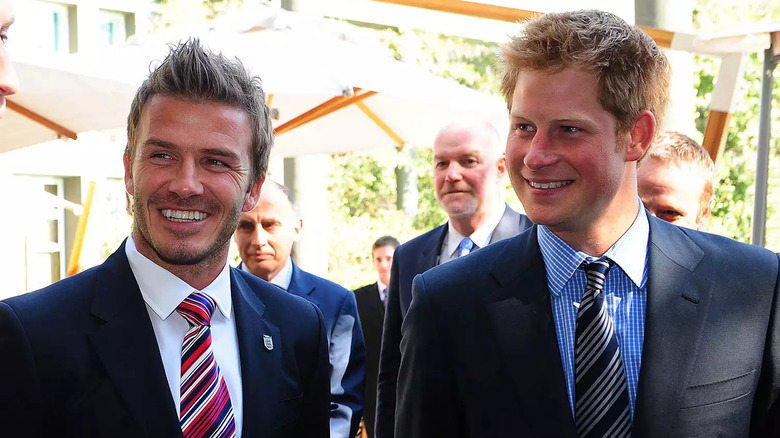 David Beckham and Prince Harry smiling