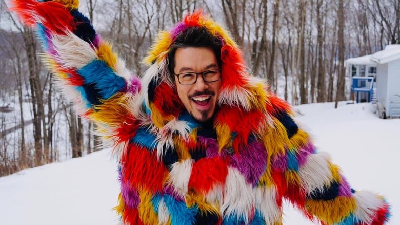 David Bromstad at home in a rainbow faux fur coat