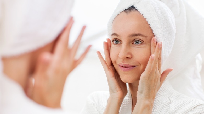 woman looking at her fresh skin