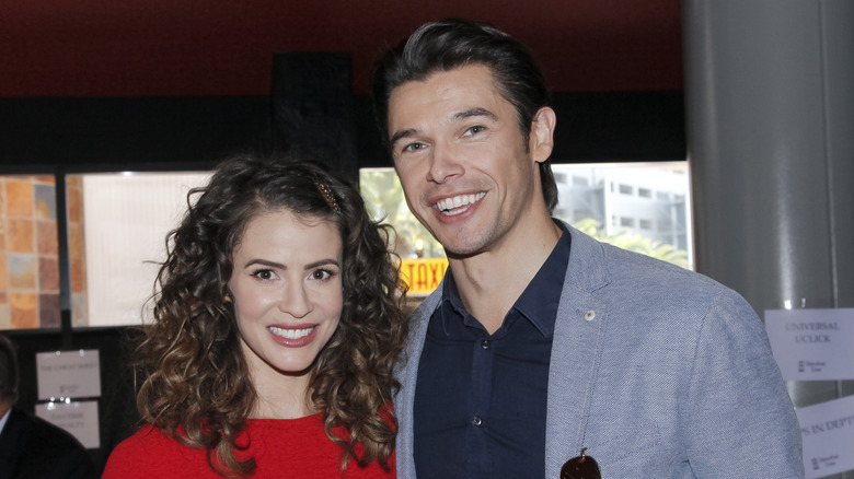 Paul Telfer and Linsey Godfrey attending an event