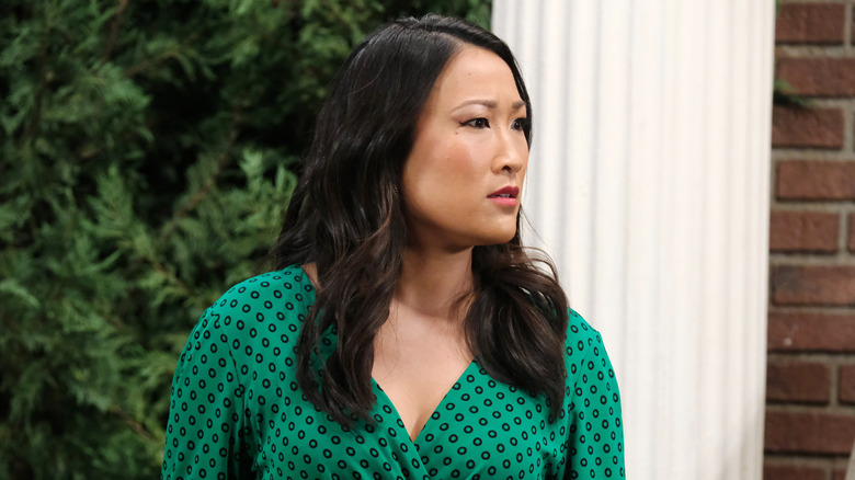 Melinda wearing a green dress