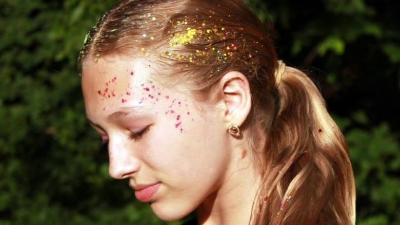 Person with hair glitter and glittery makeup