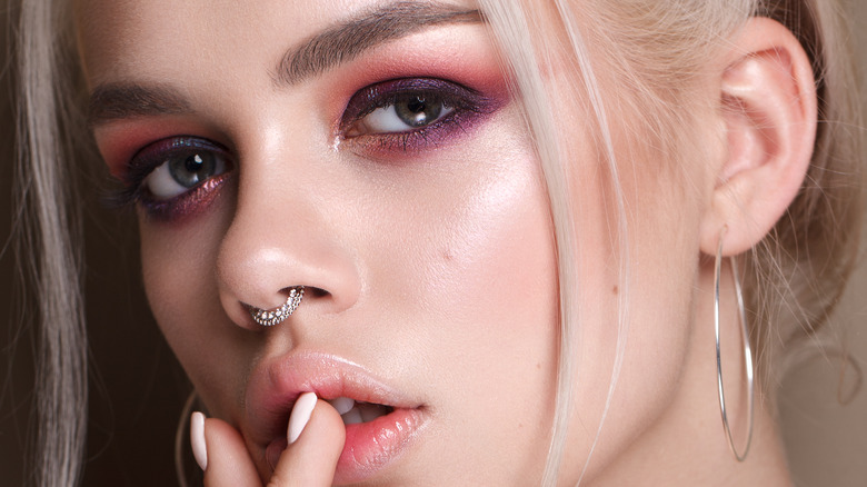 A woman wearing lilac eye makeup 