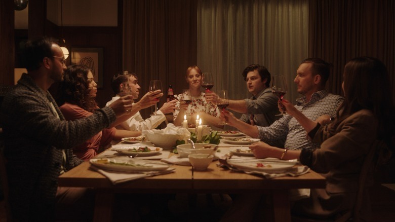 The cast of Deborah raising glasses at a table