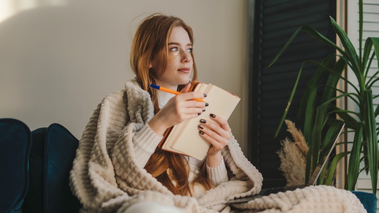 A woman writing in a journal