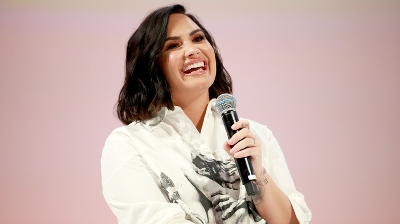 Demi Lovato speaking at an event 