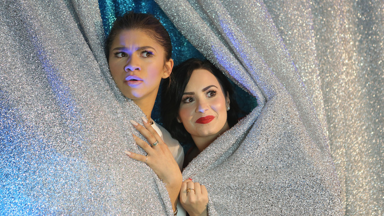 Demi Lovato and Zendaya behind curtain