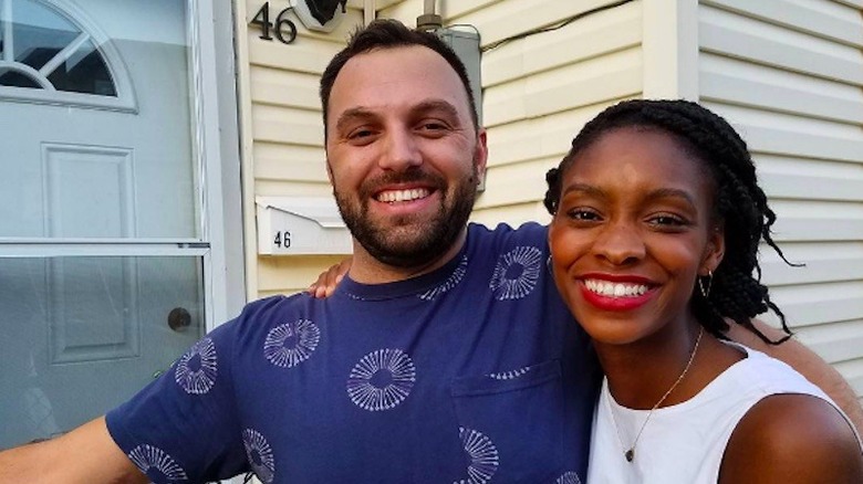 Mike and Denese Butler posing with their home