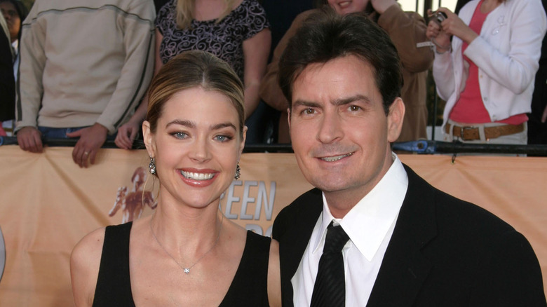 Denise Richards posing with Charlie Sheen on red carpet