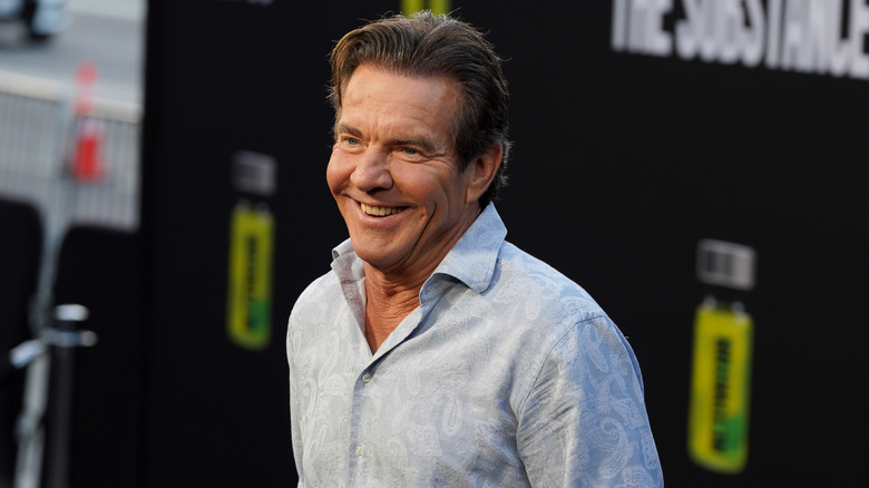 Dennis Quaid smiling in a collared shirt