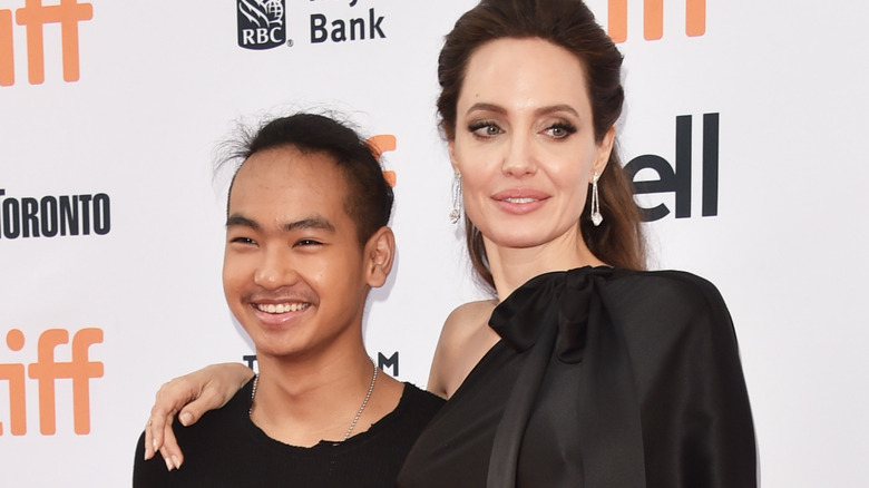 Angelina Jolie and Maddox Jolie-Pitt smiling on the red carpet 