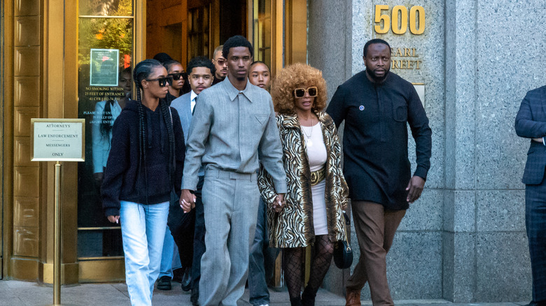 Some of P' Diddy's children family holding hands outside a courthouse