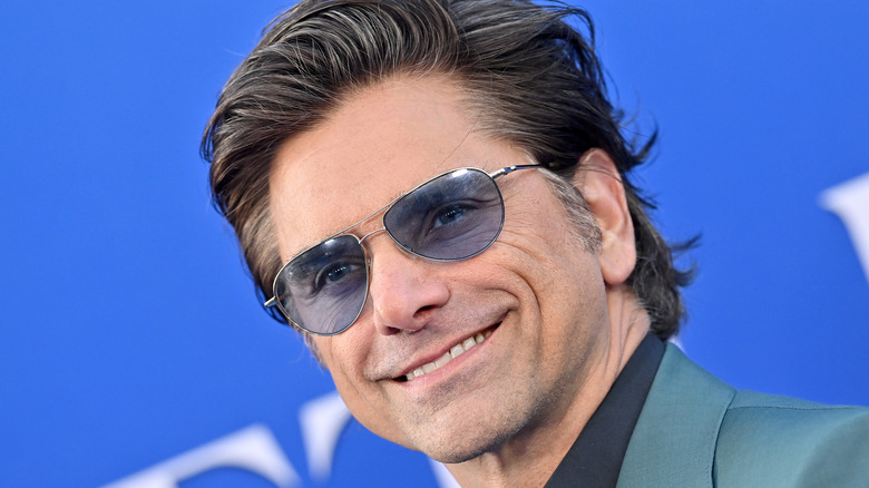 Close up of John Stamos wearing sunglasses 