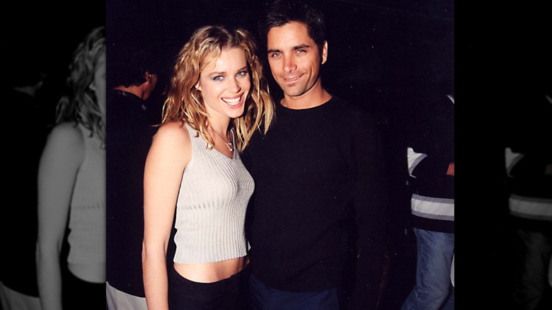 Rebecca Romijn in crop top and John Stamos