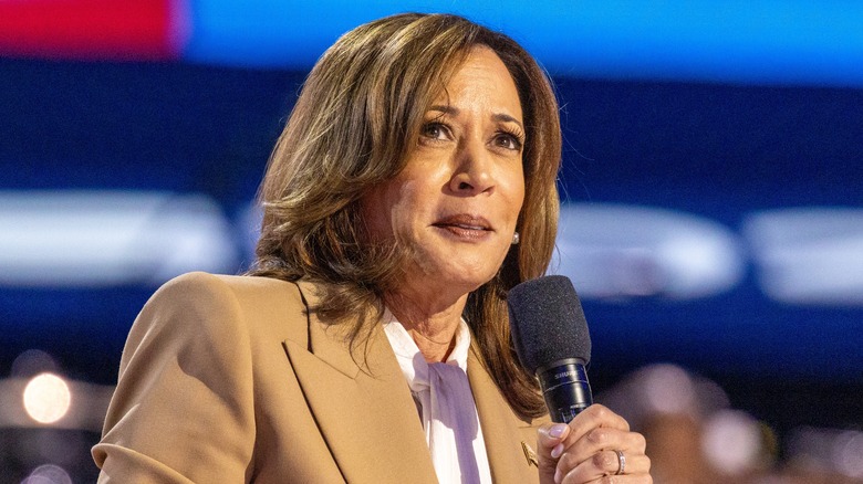 Kamala Harris speaking into a microphone