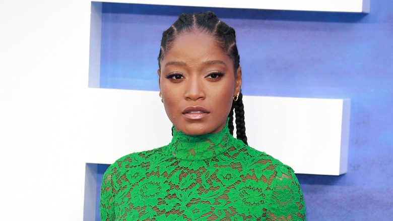 Keke Palmer poses in a green lace gown