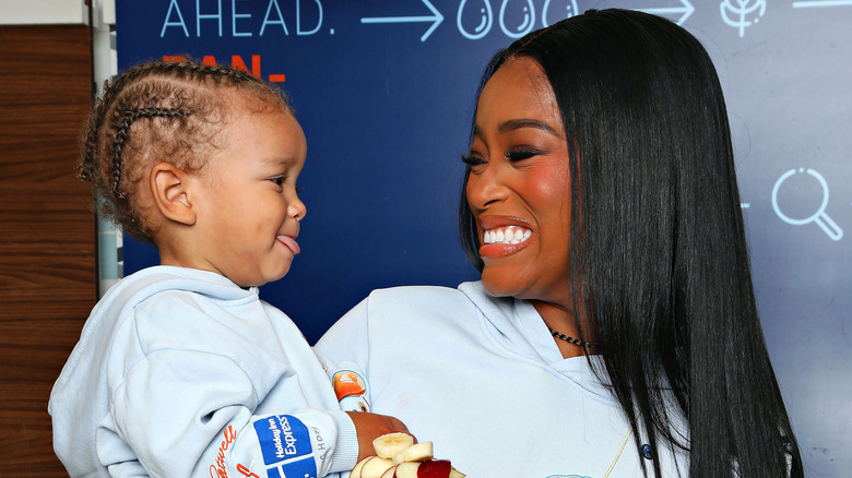 Keke Palmer smiling at her son Leodis who's tongue is sticking out