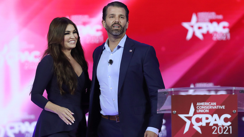 Kimberly Guilfoyle and Donald Trump Jr. standing on stage