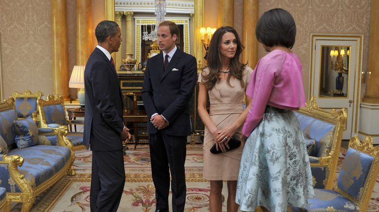 Barack and Michelle Obama chatting with Prince William and Kate Middleton