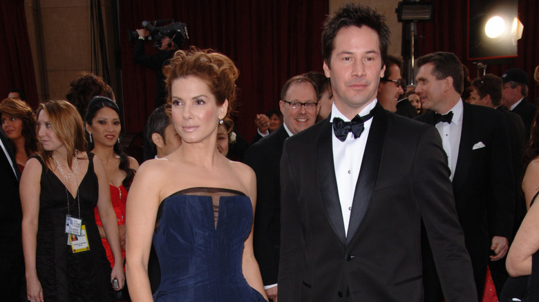 Young Sandra Bullock and Keanu Reeves on red carpet