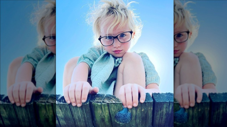 Anna Cardwell's daughter Kaitlyn leaning over dock