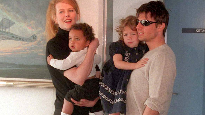 Tom Cruise and Nicole Kidman holding kids