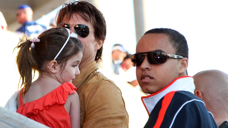 Tom, Suri, and Connor Cruise at a stadium