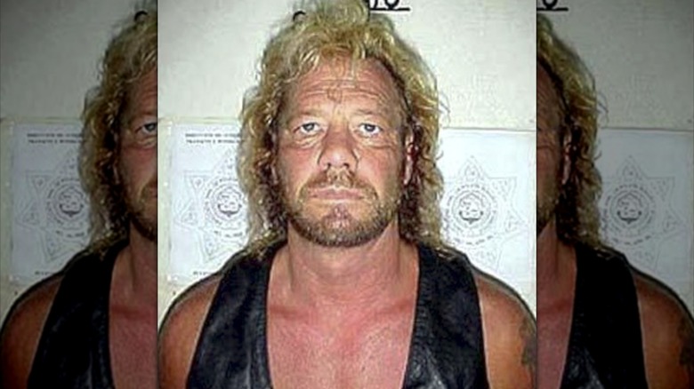 Dog the Bounty Hunter posing for a mugshot from an arrest in Mexico, 2003