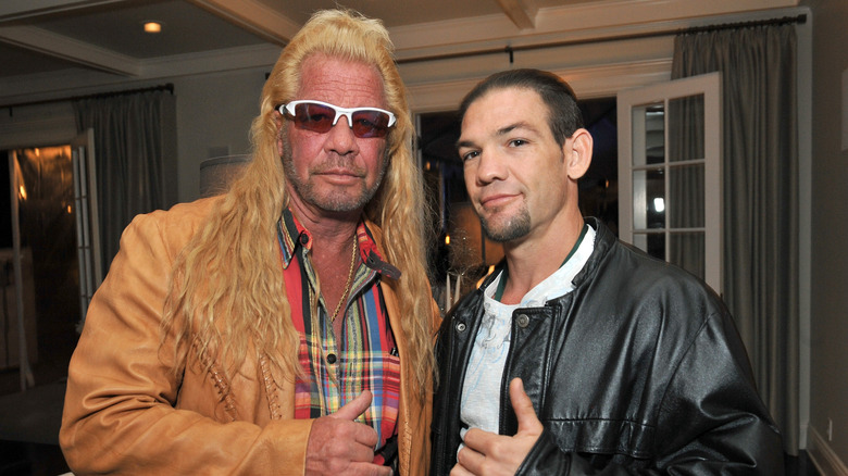 Dog the Bounty Hunter posing with his son Leland Chapman at a holiday party in 2013