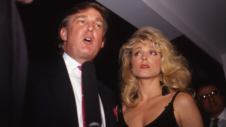 Donald Trump and Marla Maples talking at a boxing match at the Trump Plaza Hotel.