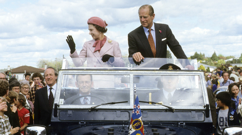 Queen Elizabeth II and Prince Philip traveling in a motorcade