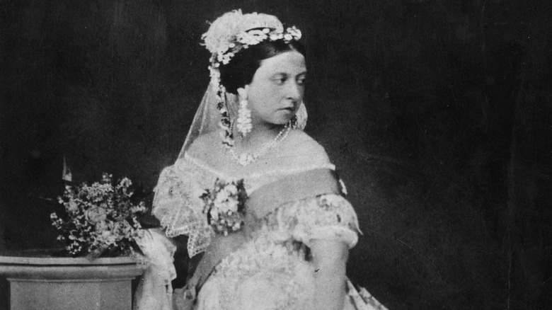 Queen Victoria posing in a lace gown