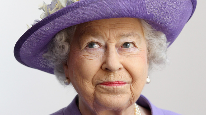 Queen Elizabeth II in purple hat
