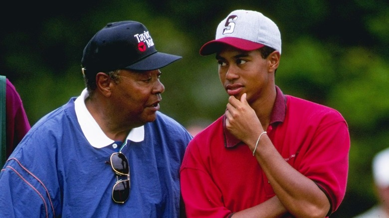 Tiger and Earl Woods talking