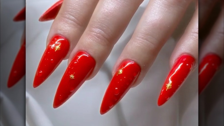 Red nails with dew drop