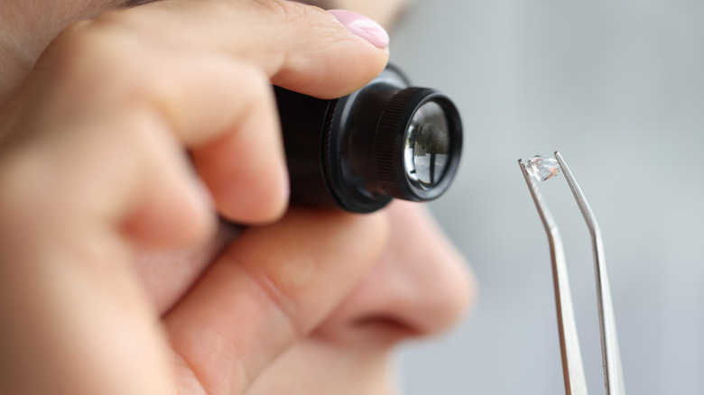 Woman examining diamond 