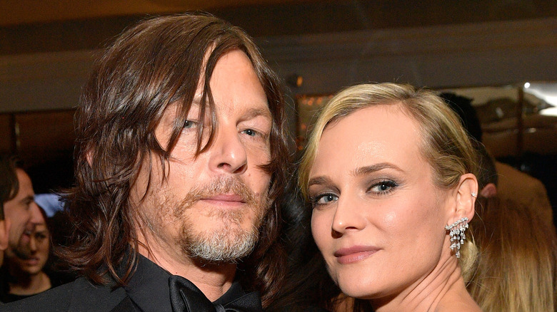 Diane Kruger and Norman Reedus pose together at an event