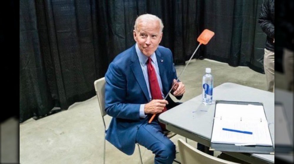 Joe Biden holding a fly swatter