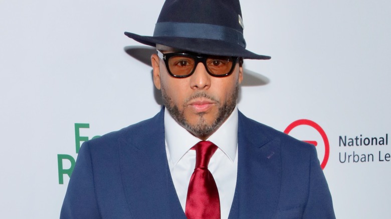 Al B. Sure looking stoic in a blue suit and matching fedora