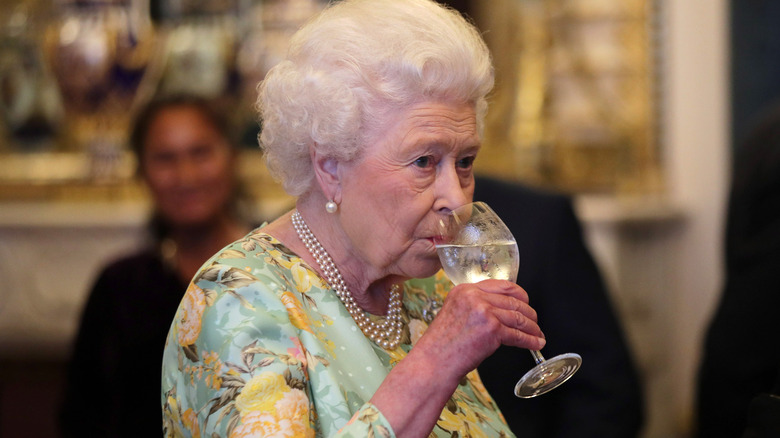 Queen Elizabeth drinking a glass of wine