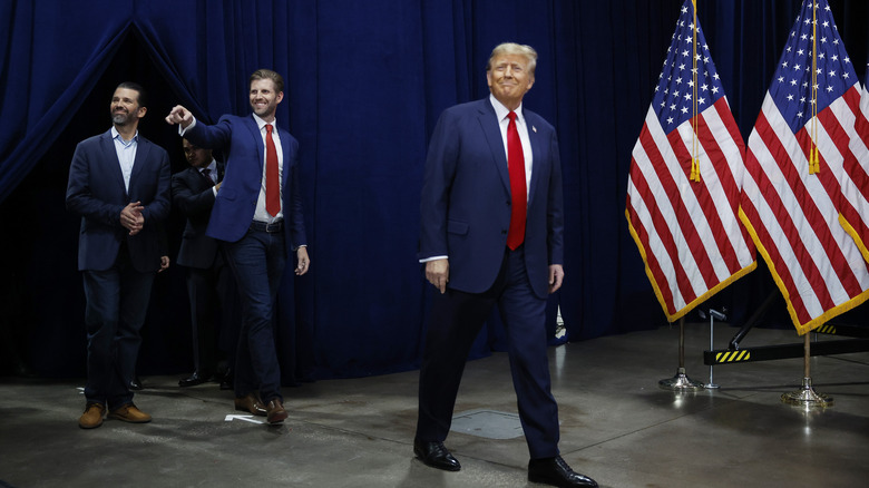 Donald, Donald Jr., and Eric Trump walking on stage