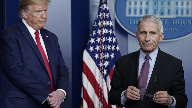 Donald Trump and Dr. Anthony Fauci standing near each other