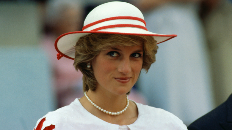 Princess Diana smiling in a hat