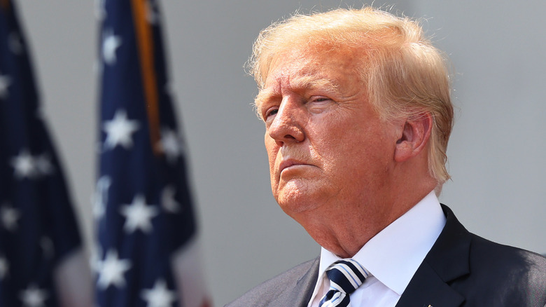 Donald Trump with American flags in the background 